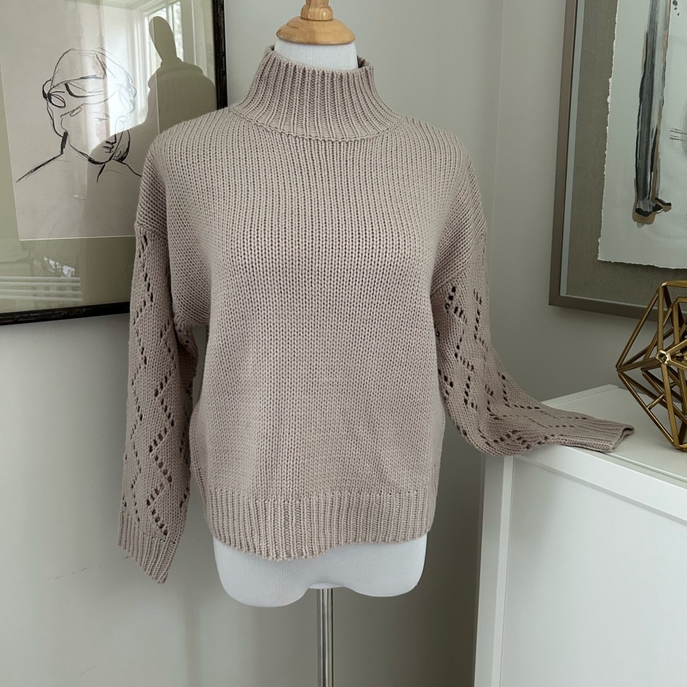 Line and Dot mock turtleneck sweater with pointelle sleeves.